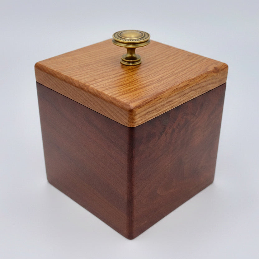 Wooden box with a metal knob on a white background